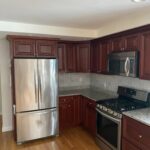 Painted cabinets, installed new white quartz countertops, and custom built an island to match.