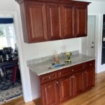 Painted cabinets, installed new white quartz countertops, and custom built an island to match.